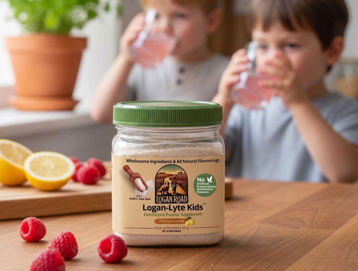 Jar of Logan Road supplement on a table with children drinking from glasses in the background.